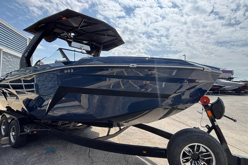 Slide: The Image of 2026 Tigé Z3 boat on trailer, sleek design under a partly cloudy sky. - 9