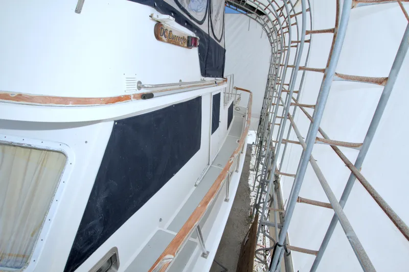 Slide: The Image of 1999 Monk 36 Trawler in storage, covered and scaffolded, side view. - 15