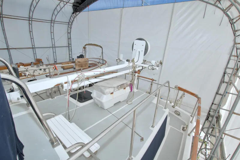 Slide: The Image of 1999 Monk 36 Trawler under cover, showcasing deck and equipment in storage. - 17