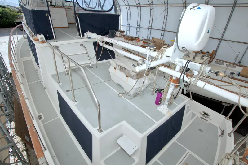 Slide: The Image of 1999 Monk 36 Trawler deck with railing and equipment in covered storage. - 18