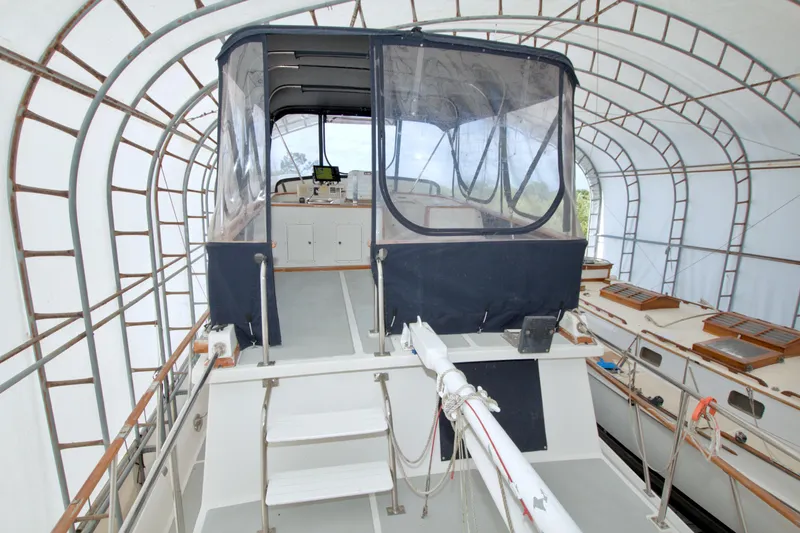 Slide: The Image of 1999 Monk 36 Trawler in covered dock, showcasing helm and navigation equipment. - 19