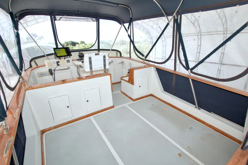 Slide: The Image of Enclosed helm area of 1999 Monk 36 Trawler with navigation equipment and seating. - 20