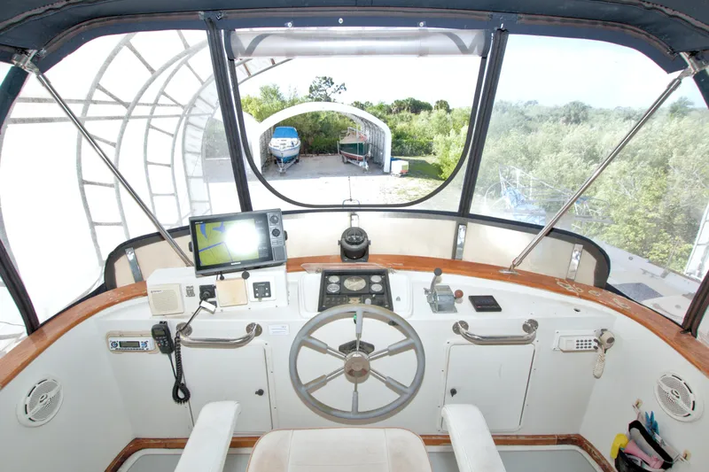 Slide: The Image of Cockpit of 1999 Monk 36 Trawler with navigation equipment and steering wheel. - 22