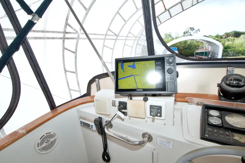 Slide: The Image of Cockpit of 1999 Monk 36 Trawler with navigation equipment and steering controls. - 24