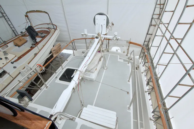 Slide: The Image of 1999 Monk 36 Trawler under maintenance, covered and scaffolded, showcasing deck and equipment. - 28