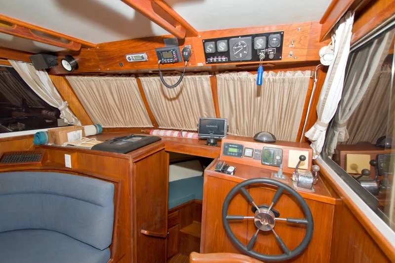 Slide: The Image of Interior of a 1999 Monk 36 Trawler with wooden helm and navigation equipment. - 33