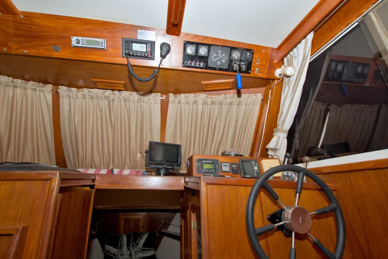 Slide: The Image of Interior helm of 1999 Monk 36 Trawler with navigation instruments and wooden finish. - 34