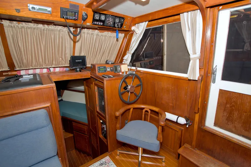 Slide: The Image of Interior of a 1999 Monk 36 Trawler with wooden helm and navigation equipment. - 35