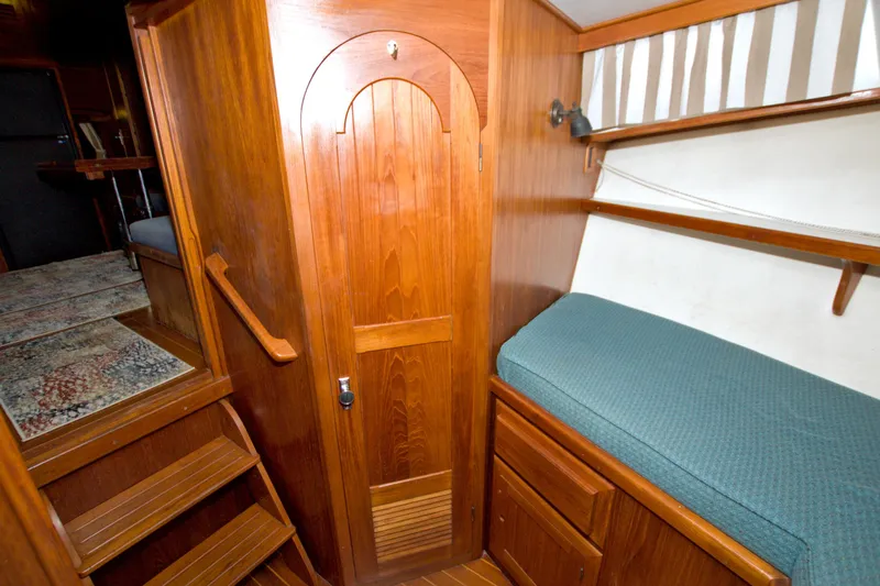 Slide: The Image of Wooden interior of 1999 Monk 36 Trawler with stairs, door, and cozy sleeping area. - 41