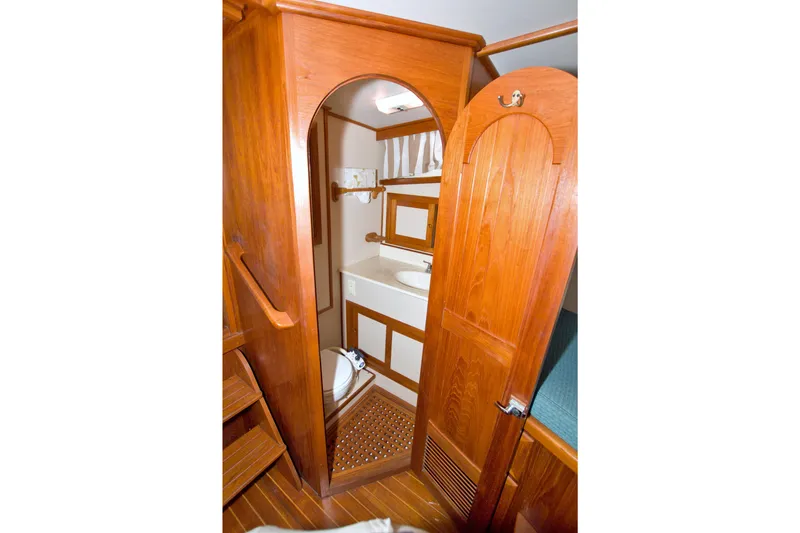 Slide: The Image of Wood-paneled bathroom interior of 1999 Monk 36 Trawler, featuring sink and toilet. - 42