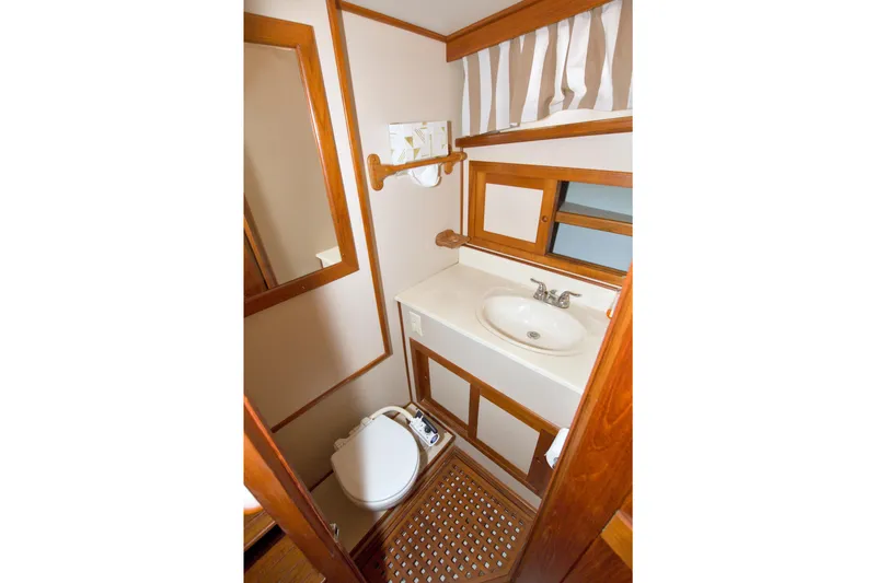 Slide: The Image of Bathroom interior of 1999 Monk 36 Trawler with wooden accents and compact design. - 43