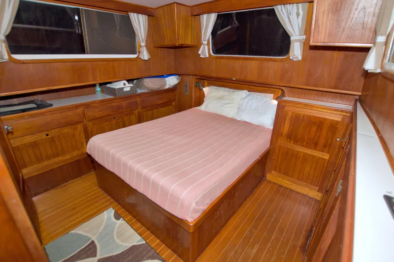 Slide: The Image of Cozy cabin interior of 1999 Monk 36 Trawler with wooden furnishings and a comfortable bed. - 46