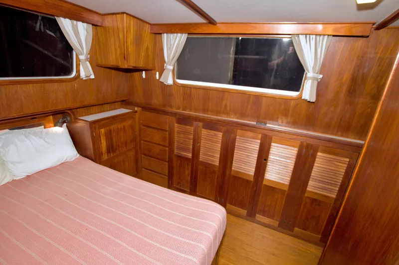 Slide: The Image of Cozy wooden cabin interior of 1999 Monk 36 Trawler with bed and storage. - 47