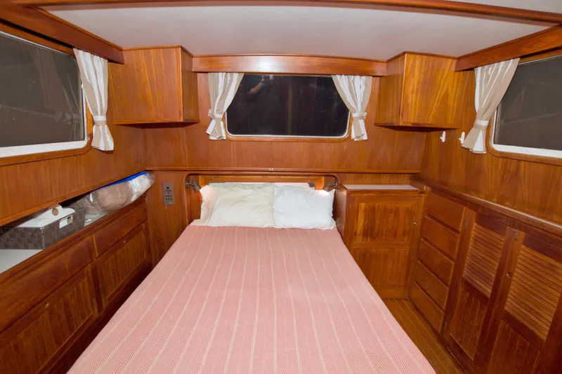 Slide: The Image of Cozy cabin interior of 1999 Monk 36 Trawler with wood paneling and bed. - 48