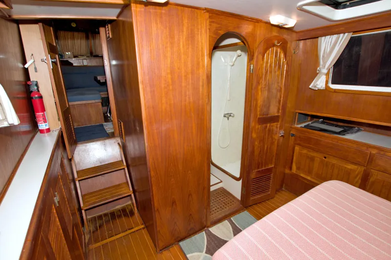 Slide: The Image of Interior of 1999 Monk 36 Trawler with wooden cabinetry and compact shower area. - 50