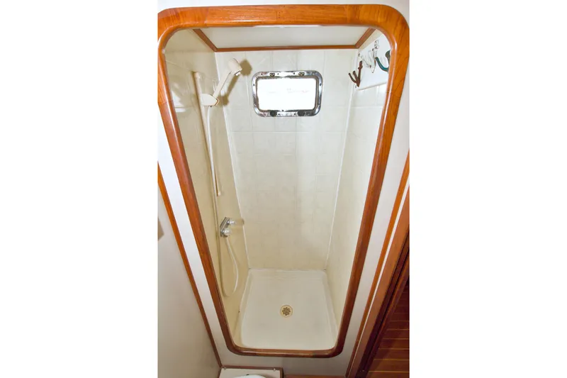 Slide: The Image of Shower area in 1999 Monk 36 Trawler with wooden trim and porthole window. - 51