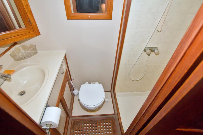 Slide: The Image of Bathroom interior of 1999 Monk 36 Trawler with shower, sink, and toilet. - 52