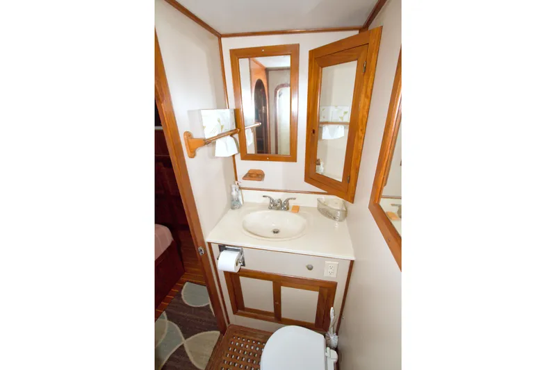 Slide: The Image of Bathroom interior of 1999 Monk 36 Trawler with wooden accents and mirror. - 53