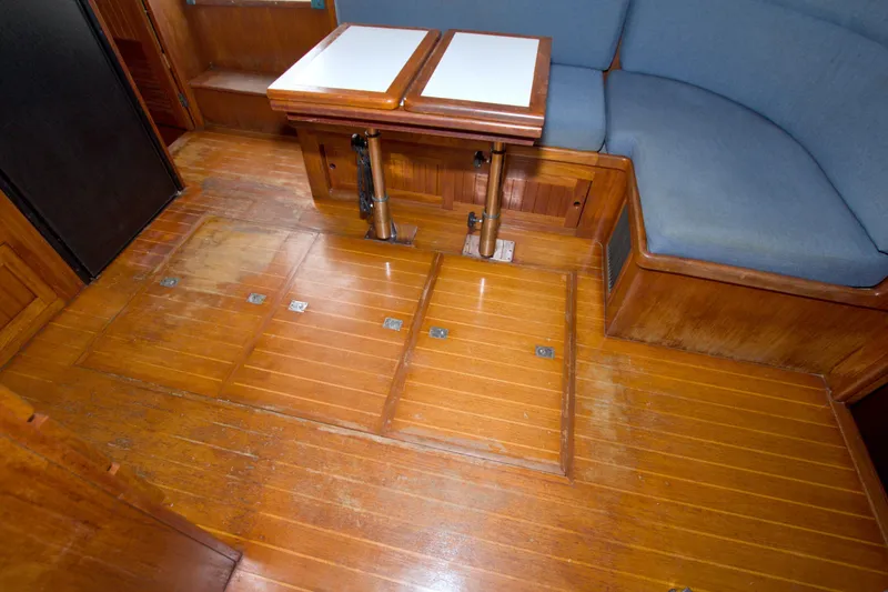 Slide: The Image of Interior of 1999 Monk 36 Trawler with wooden flooring and seating area. - 54
