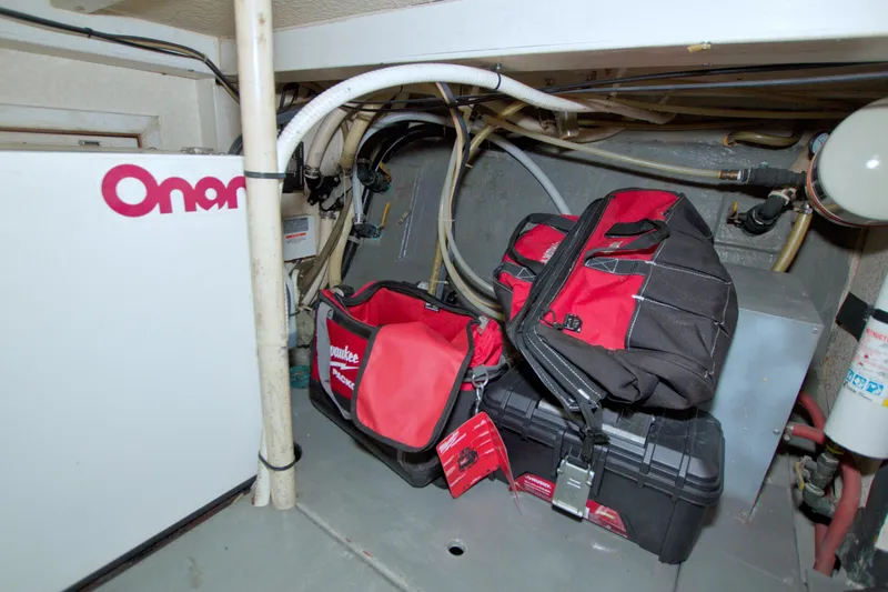 Slide: The Image of Engine room of 1999 Monk 36 Trawler with tools and Onan generator. - 59