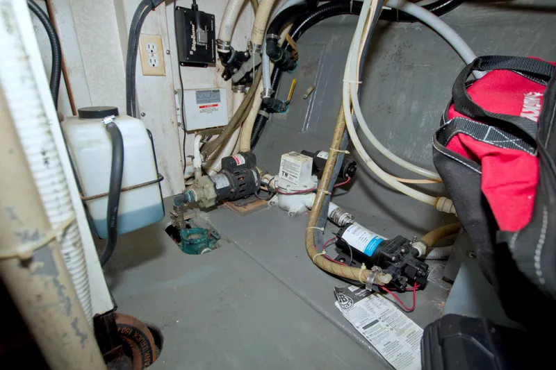 Slide: The Image of Engine room of a 1999 Monk 36 Trawler with various mechanical components. - 60