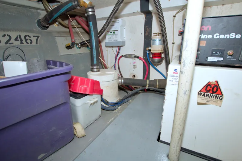 Slide: The Image of Engine room of a 1999 Monk 36 Trawler with generator and storage containers. - 63