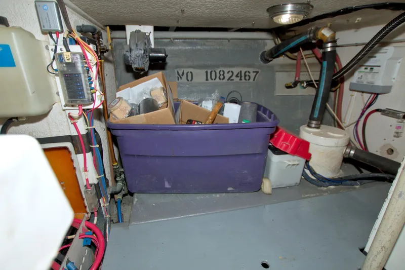 Slide: The Image of Engine room of a 1999 Monk 36 Trawler with storage bin and wiring. - 64