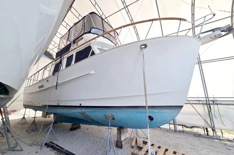 Slide: The Image of 1999 Monk 36 Trawler boat in dry dock, under protective cover. - 70