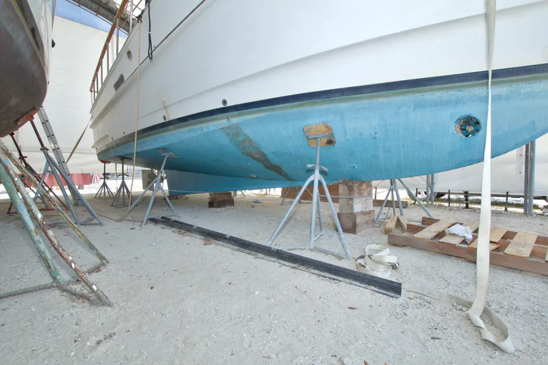 Slide: The Image of 1999 Monk 36 Trawler on stands, undergoing maintenance in a boatyard. - 71