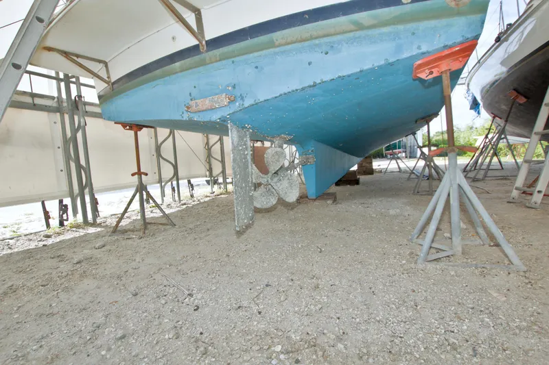 Slide: The Image of 1999 Monk 36 Trawler on stands, showing blue hull and propeller. - 74