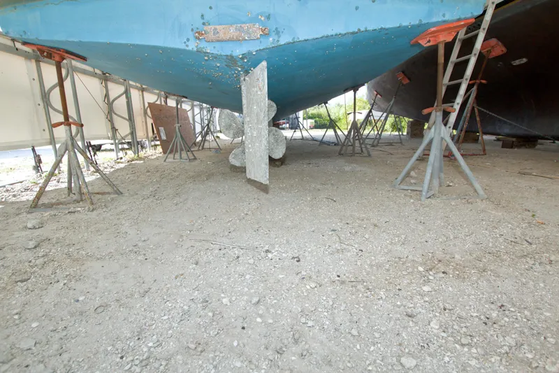 Slide: The Image of Underneath view of a 1999 Monk 36 Trawler on dry dock with supports. - 75