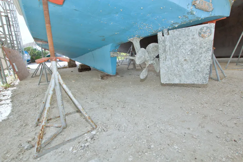 Slide: The Image of Bottom view of a 1999 Monk 36 Trawler on stands, showing propeller and rudder. - 76