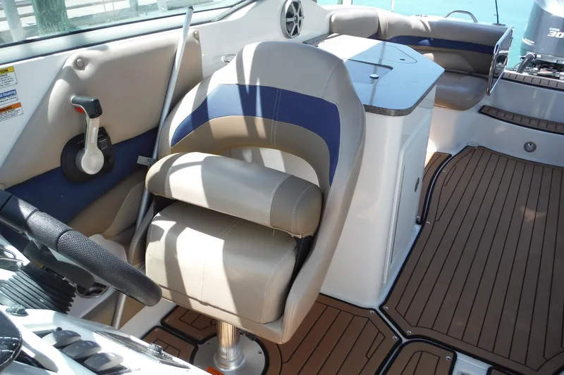 Slide: The Image of 2018 Hurricane SunDeck 2690 OB boat interior with helm seat and control panel. - 13