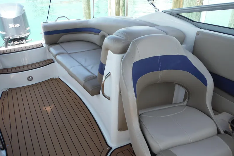 Slide: The Image of 2018 Hurricane SunDeck 2690 OB boat interior with cushioned seating and wood-style flooring. - 14