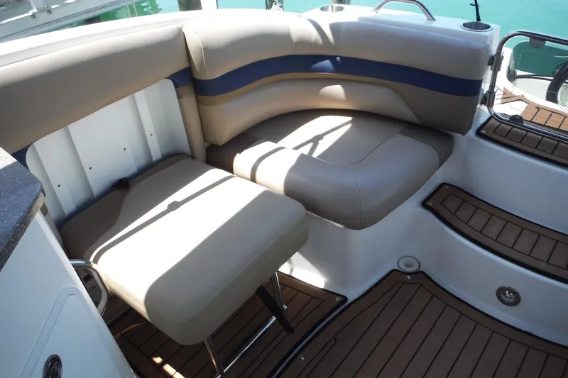 Slide: The Image of 2018 Hurricane SunDeck 2690 OB boat interior with cushioned seating and wood-style flooring. - 15