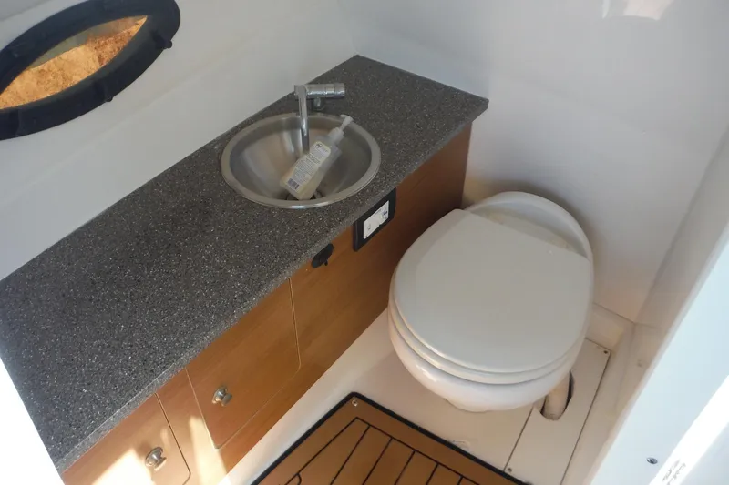 Slide: The Image of 2018 Hurricane SunDeck 2690 OB boat bathroom with sink and toilet. - 20