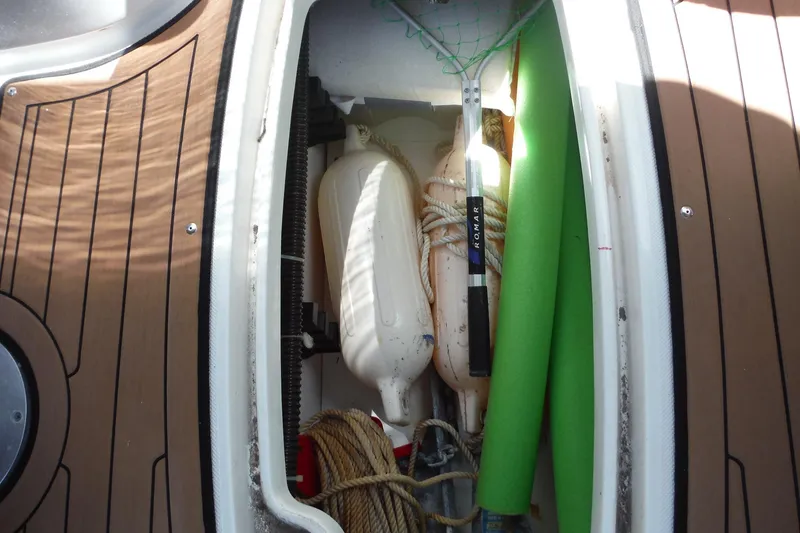 Slide: The Image of Storage compartment of 2018 Hurricane SunDeck 2690 OB with boating accessories. - 21