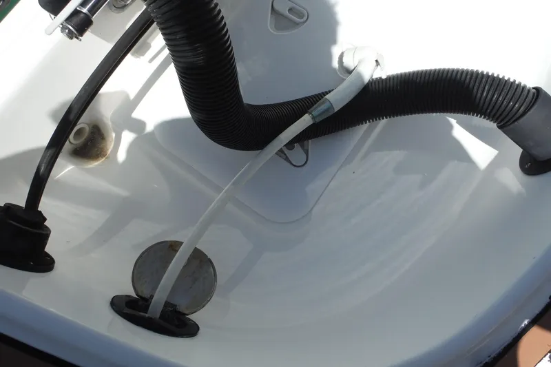 Slide: The Image of 2018 Hurricane SunDeck 2690 OB boat interior with hoses and fittings. - 23