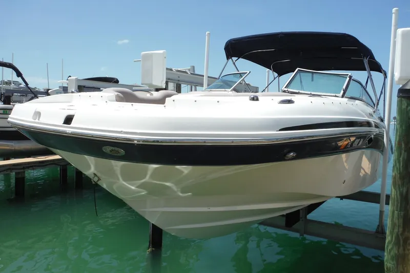 Slide: The Image of 2018 Hurricane SunDeck 2690 OB boat docked in clear blue water. - 3