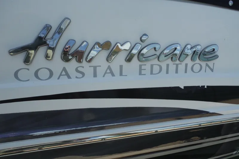 Slide: The Image of 2018 Hurricane SunDeck 2690 OB Coastal Edition logo on boat exterior. - 30
