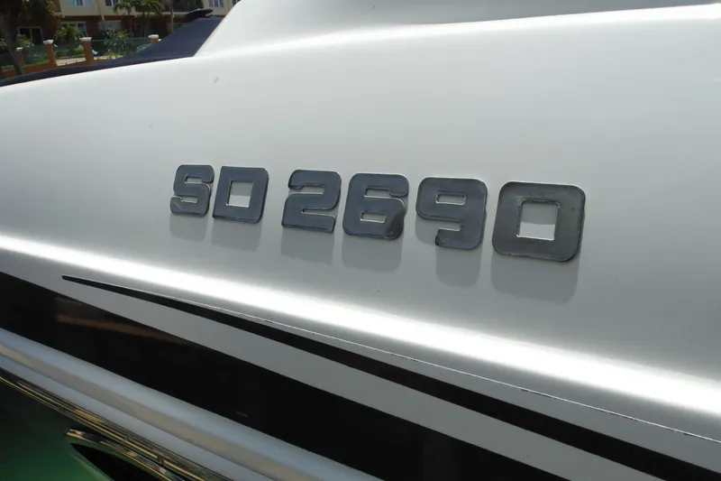 Slide: The Image of 2018 Hurricane SunDeck 2690 OB boat model emblem on white surface. - 31