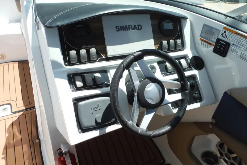 Slide: The Image of Steering console of 2018 Hurricane SunDeck 2690 OB boat with Simrad and Polk systems. - 7