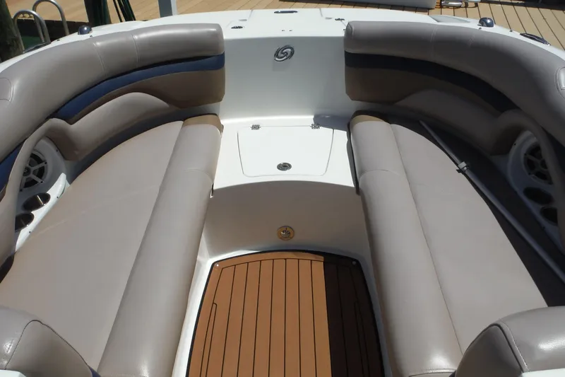 Slide: The Image of 2018 Hurricane SunDeck 2690 OB boat interior with spacious seating and teak flooring. - 9
