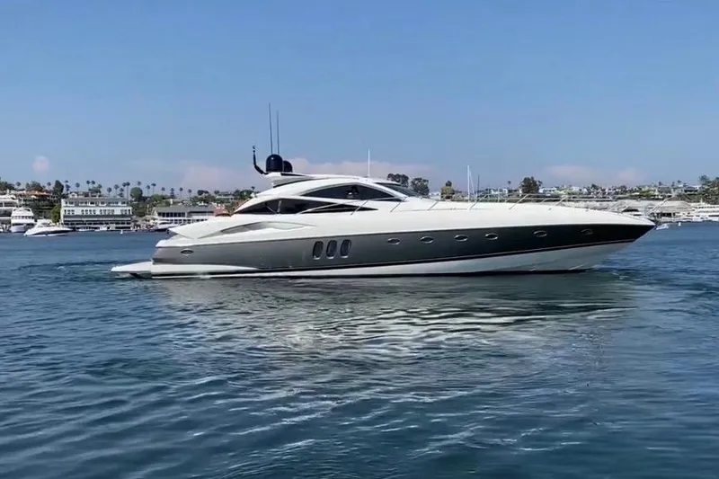 The Image of 2004 Sunseeker Predator 68 yacht cruising on a sunny day in a marina. - 1