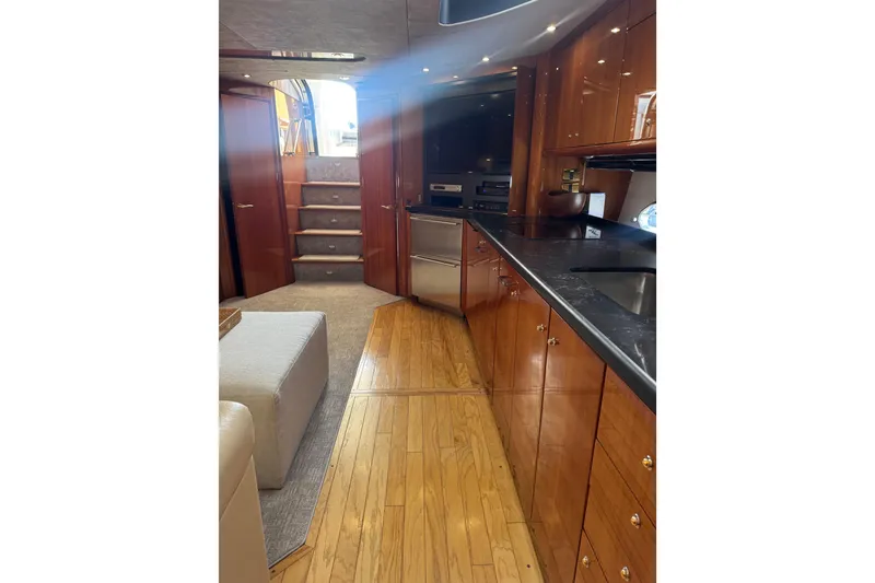 Slide: The Image of Luxurious interior of 2004 Sunseeker Predator 68 yacht with wooden cabinetry and modern amenities. - 10
