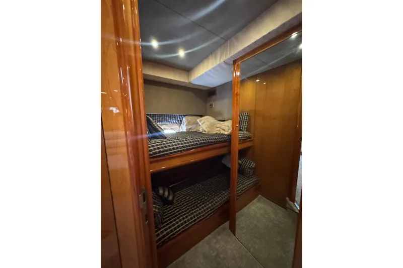 Slide: The Image of Interior cabin of 2004 Sunseeker Predator 68 yacht with wooden finish and bunk beds. - 16