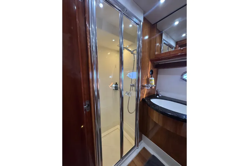 Slide: The Image of Luxurious bathroom in 2004 Sunseeker Predator 68 yacht with shower and sink. - 21