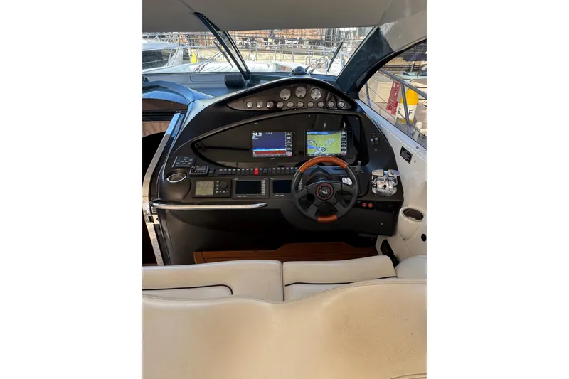 Slide: The Image of Helm of 2004 Sunseeker Predator 68 yacht with navigation screens and controls. - 22