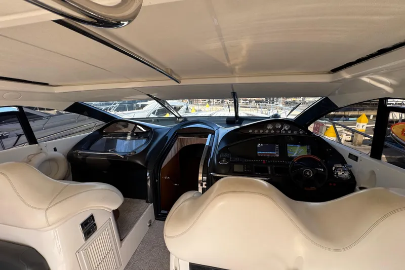 Slide: The Image of Interior view of 2004 Sunseeker Predator 68 yacht cockpit with modern controls and seating. - 23