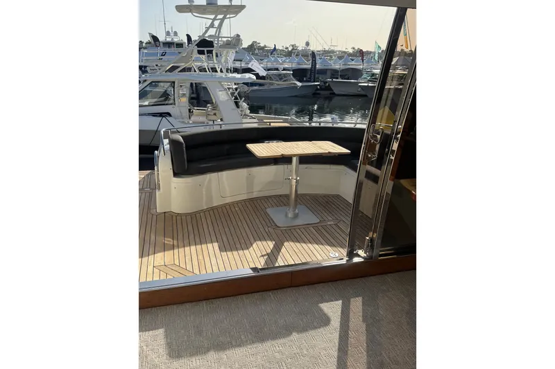 Slide: The Image of 2004 Sunseeker Predator 68 yacht with teak deck and seating area at marina. - 24